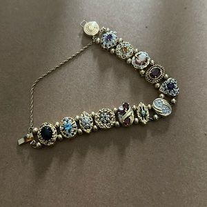 14k, 585, slider bracelet with different gems. Approximately 7 inches.